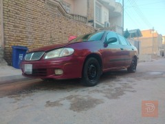 نيسان سني موديل 2000 لون ماروني للبيع في ميسان
