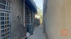 نص دونم يحتوي على بيت ومشتملات ومحل للبيع في بغداد