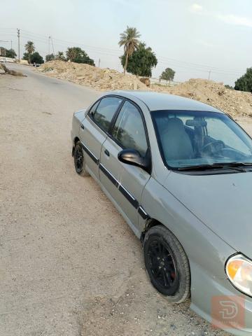 كيا ريو 2001 لون اسمنتي للبيع في بغداد