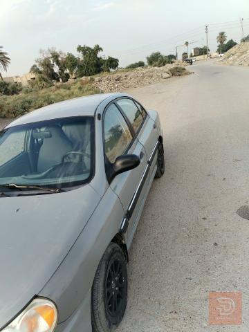 كيا ريو 2001 لون اسمنتي للبيع في بغداد